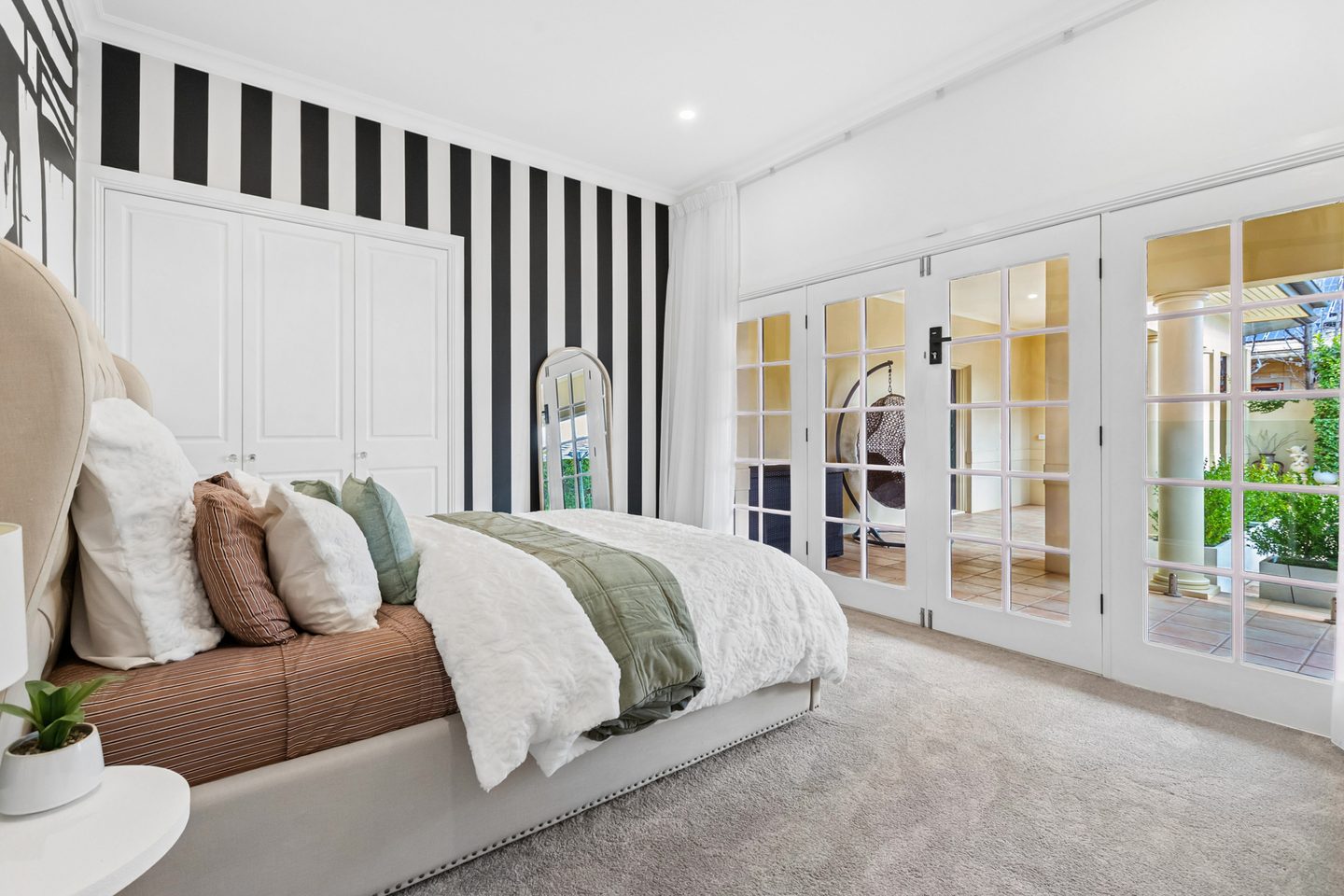 Bedroom with glazed doors opening to the covered patio