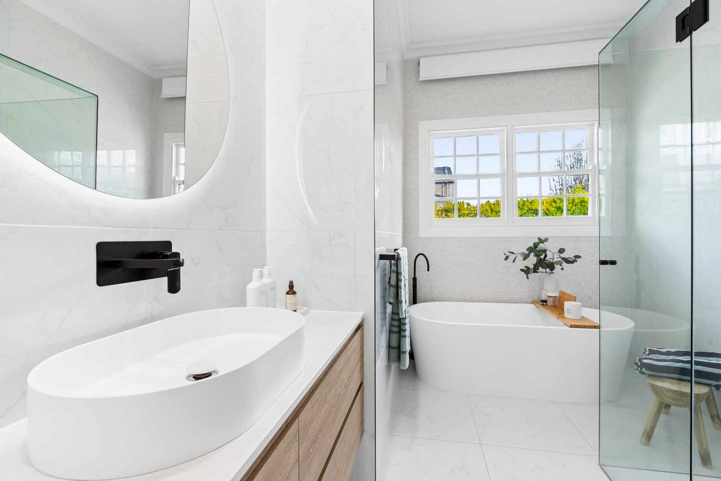 Bathroom with freestanding bath, shower and wall-hung vanity
