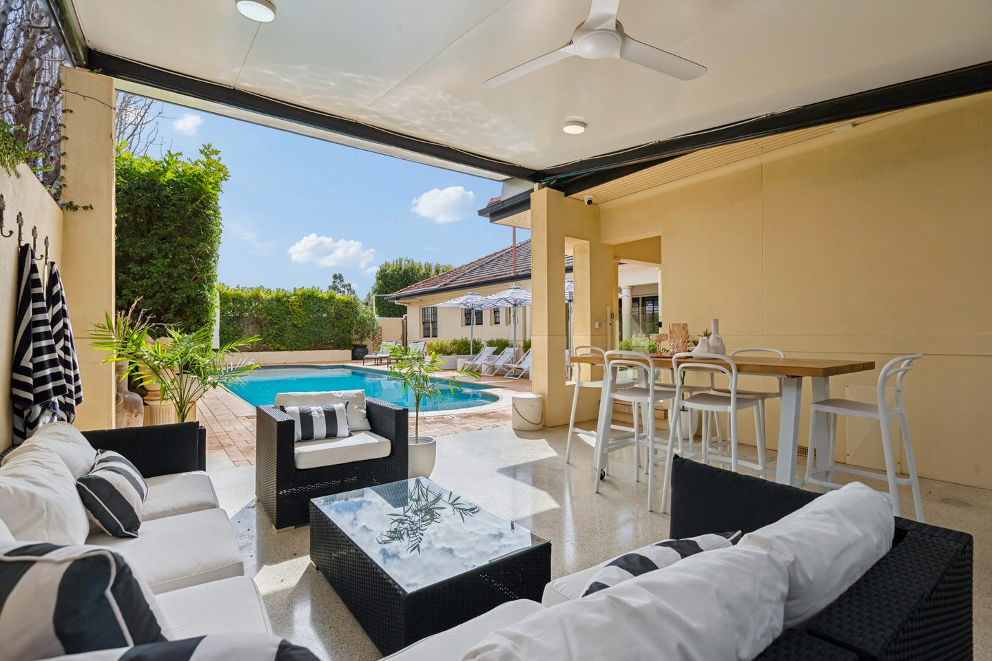 Covered outdoor entertaining area opening towards the swimming pool