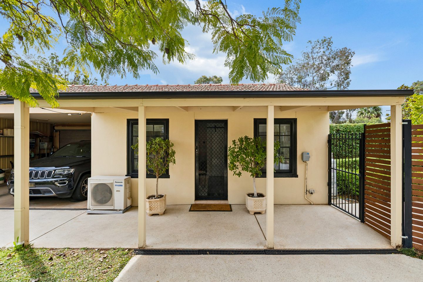 Bungalow exterior and covered porch beside the carport
