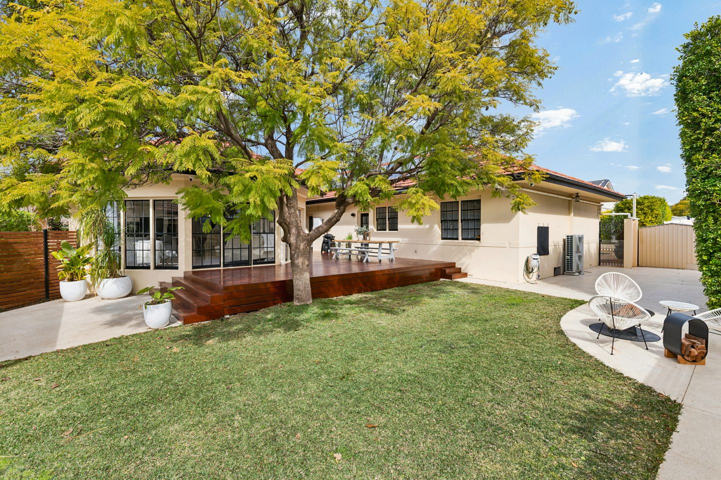Lawn and established tree beside the deck and sunroom windows