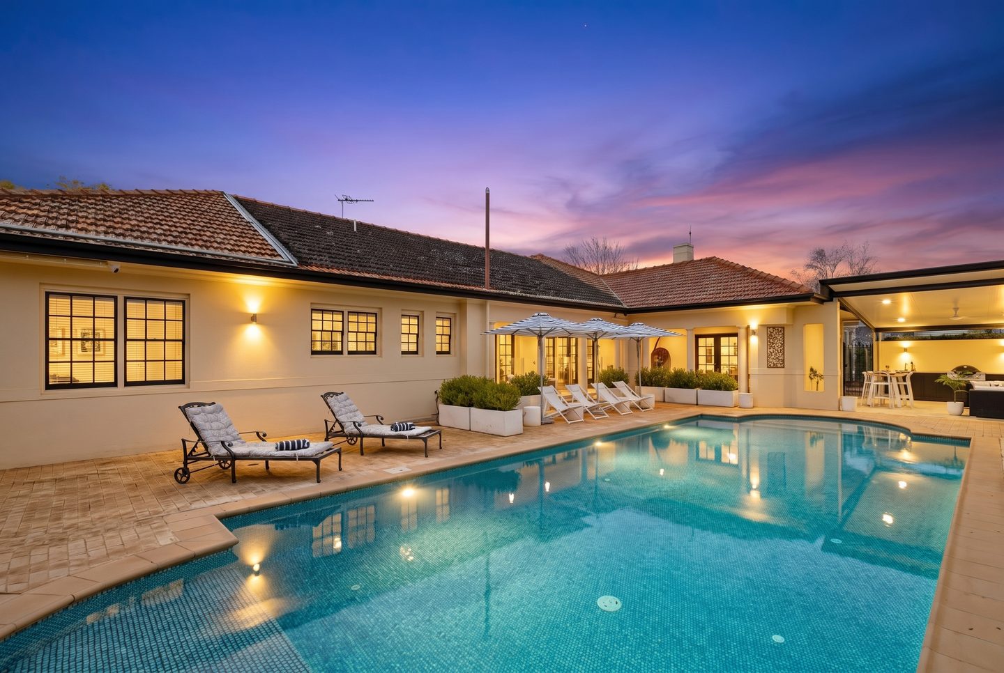 Villa Sol's pool and covered entertaining area at dusk