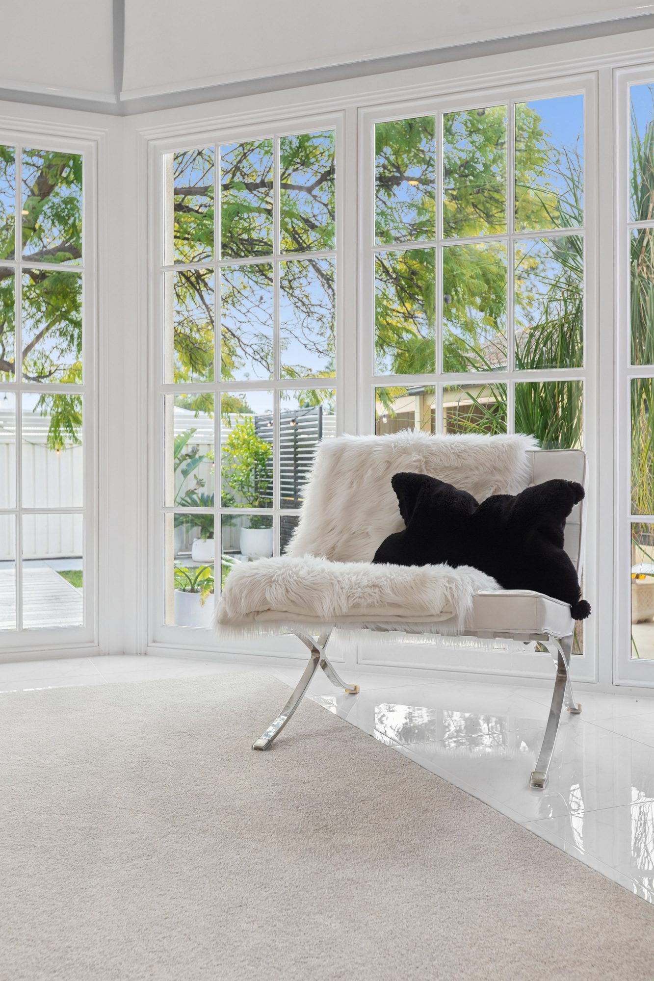 Sunroom windows framing the greenery outside